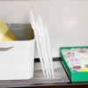 A white container holds clear plastic cutting dies for fruit and flower scrapbooking
