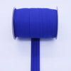 A roll of bright blue durable bias tape binding ribbon with a metal core and a blue plastic rod.