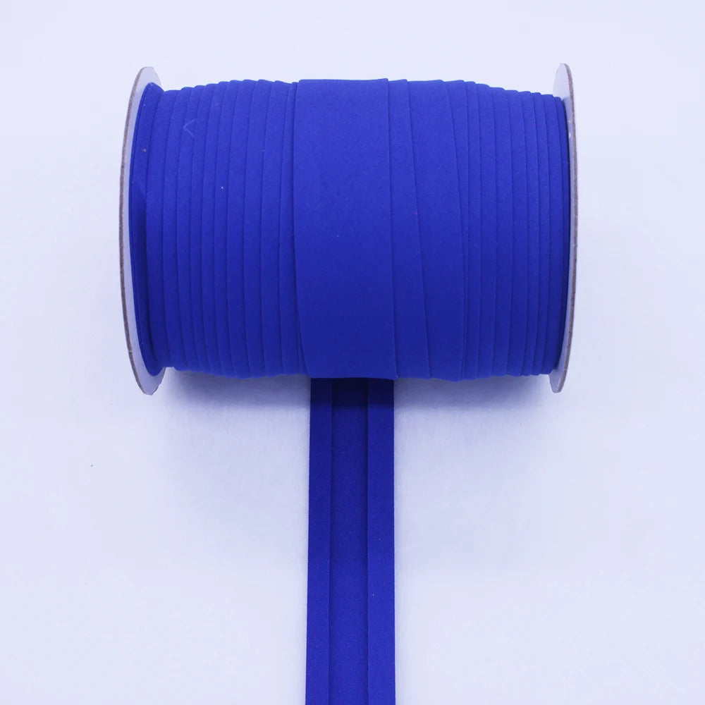A roll of bright blue durable bias tape binding ribbon with a metal core and a blue plastic rod.