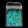 A clear plastic bag filled with vibrant teal and green sparkly resin glitter filler for epoxy art