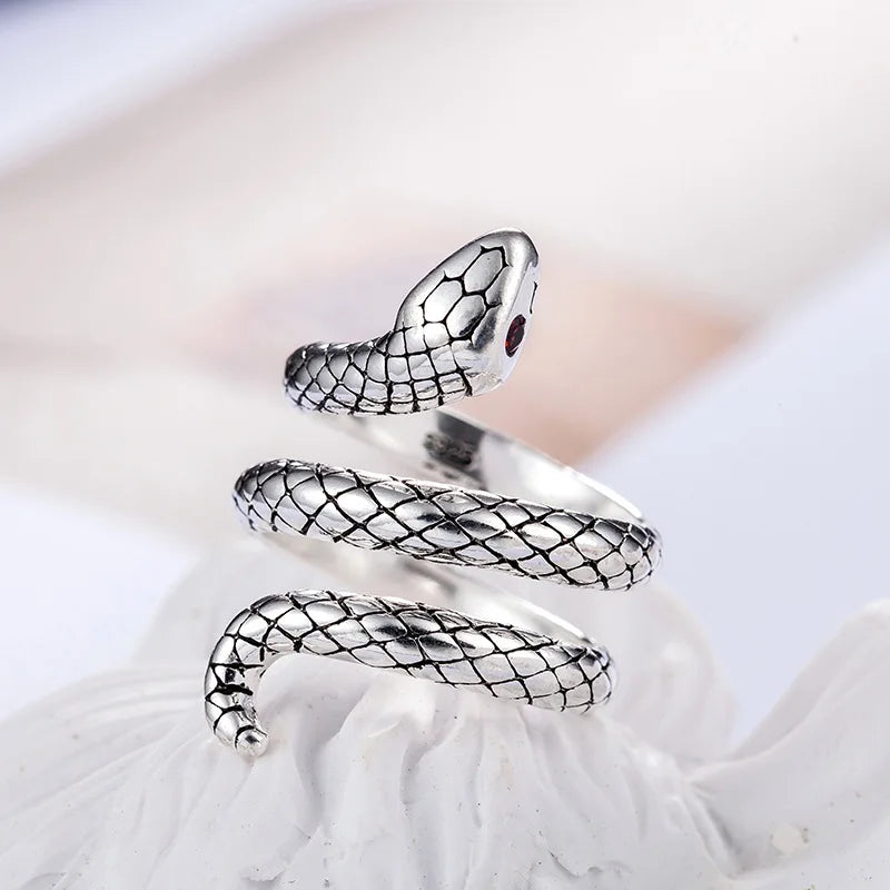 Silver animal finger rings featuring a coiled snake design displayed on a white background.