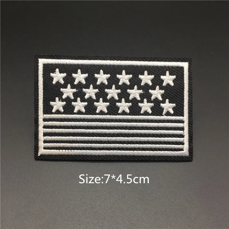 Black embroidered patch featuring white stars and horizontal stripes