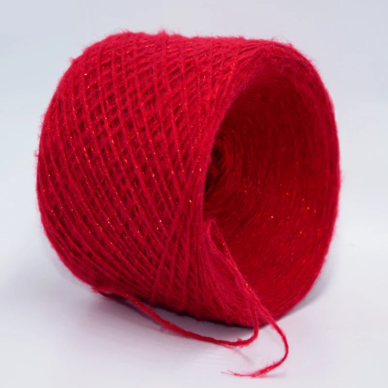 A spool of bright red metallic merino wool yarn for hand knitting