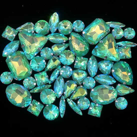 A collection of 50 faceted, brilliant blue-green and aqua colored silver claw rhinestones.