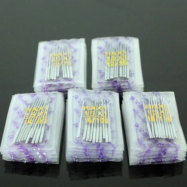 A set of universal sewing machine needles packaged in clear plastic, showing various sizes and types.