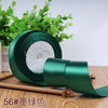 Roll of emerald green satin ribbon for gift wrapping and DIY crafts