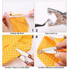 A set of tools for sewing and fabric work including a sewing clip, tweezers, scissors, and a fabric.