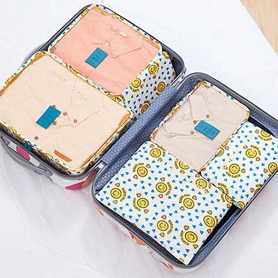A set of six fabric storage organizers for clothes, featuring various pastel and patterned fabrics.