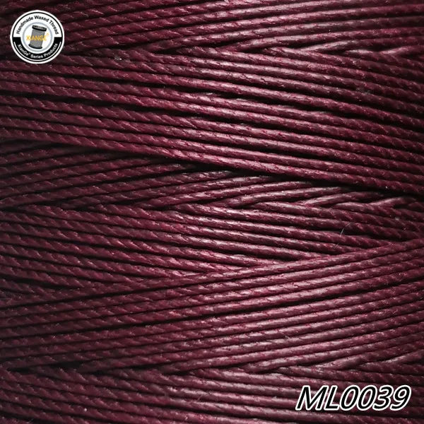 A spool of deep maroon waxed thread embroidery cord with a black label and the product code ML0039.
