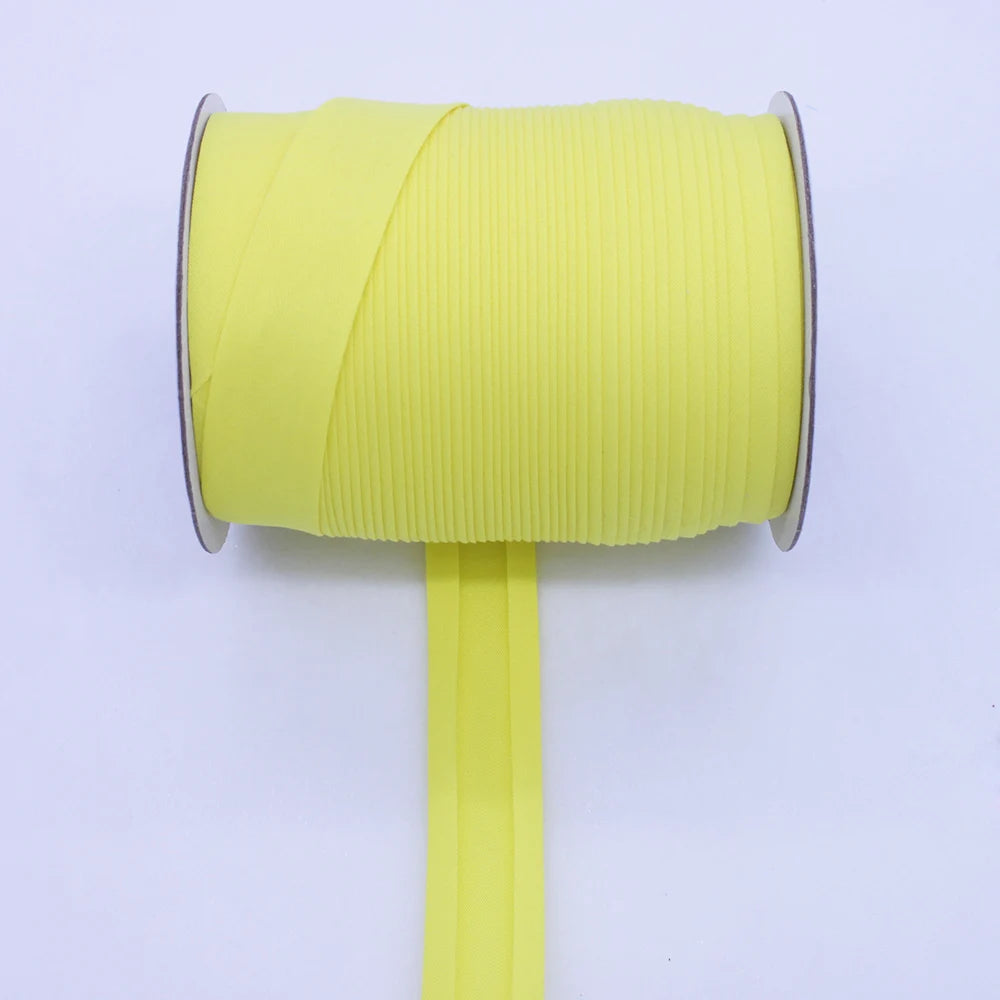 A roll of bright yellow durable bias tape binding ribbon with a vertical strip extending from the center.