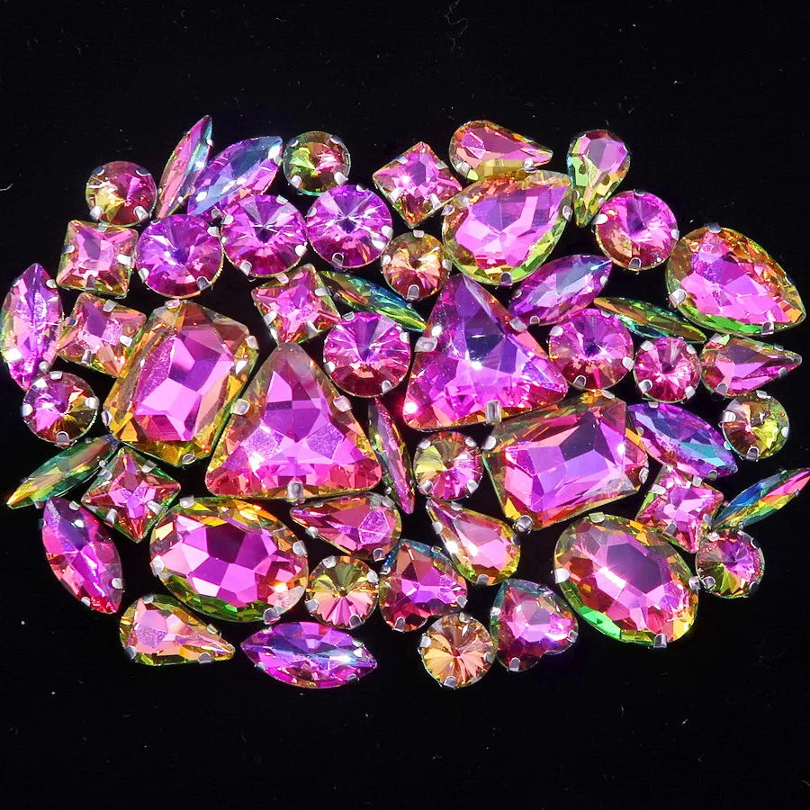 A close-up of a set of colorful pink and green rhinestones arranged in a decorative pattern.