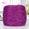 A ball of vibrant magenta metallic silk yarn used for crocheting and knitting.
