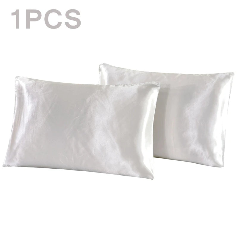 One pair of white silky satin pillowcases shown flat.