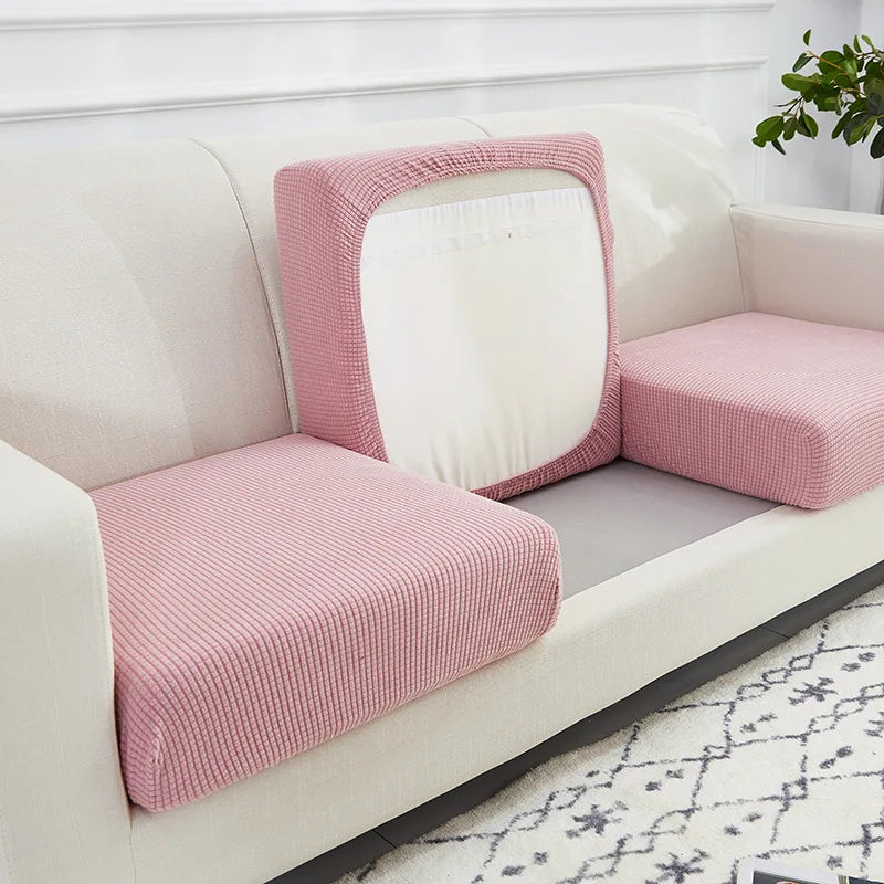 A pink textured seat cushion cover is shown on a white sofa, featuring a rectangular mirror design.