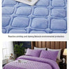 Purple crystal velvet quilted bedspread with a diamond pattern on a bed.