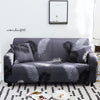 A dark gray stretch floral elastic sofa cover featuring a black and white palm leaf pattern.