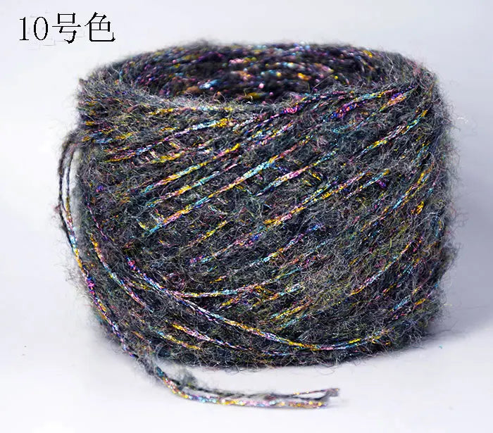 A ball of metallic gray merino wool yarn with iridescent fibers for hand knitting