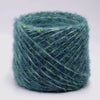 A skein of teal metallic merino wool yarn for hand knitting