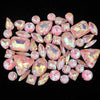 A collection of pink and iridescent faceted rhinestones in various shapes and sizes.