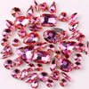 A scattering of pink and magenta silver claw rhinestones on a white background.