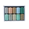 A box containing ten spools of polyester sewing thread in various shades of beige, pink, blue, and green.