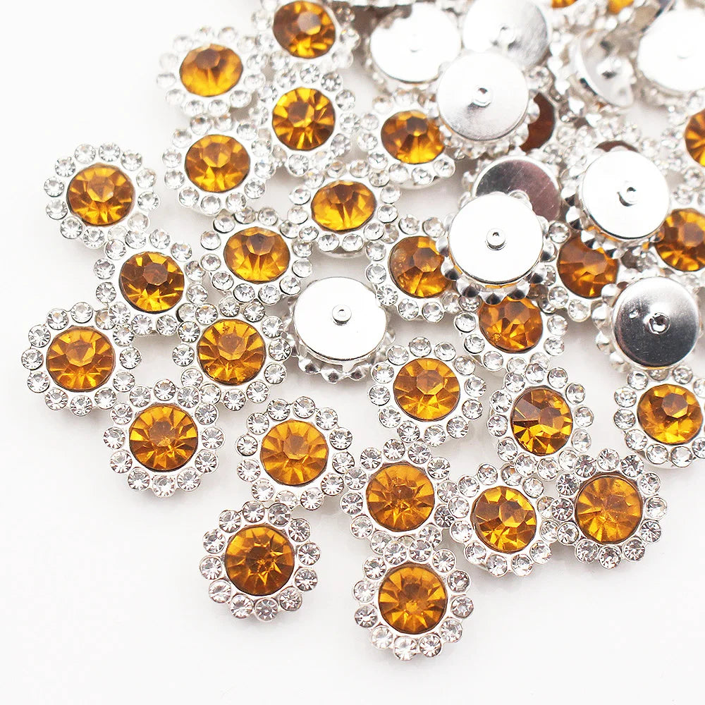 Silver and amber crystal rhinestone sew-on buttons arranged in a floral pattern