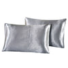 A stack of smooth, silver-gray silky satin pillowcases.