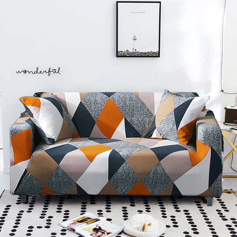 A modern sofa covered in a geometric pattern of gray, black, white, and orange fabric.