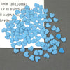 A pile of light blue felt heart appliques for crafting and decoration.