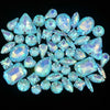 A close-up view of a set of light blue silver claw rhinestones arranged on a dark background.