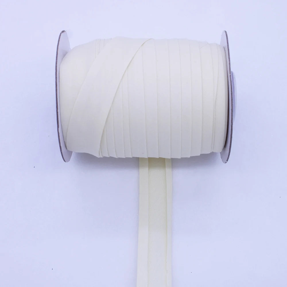 A roll of beige durable bias tape binding ribbon on a white stand.