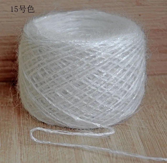 A ball of white metallic merino wool yarn used for hand knitting.