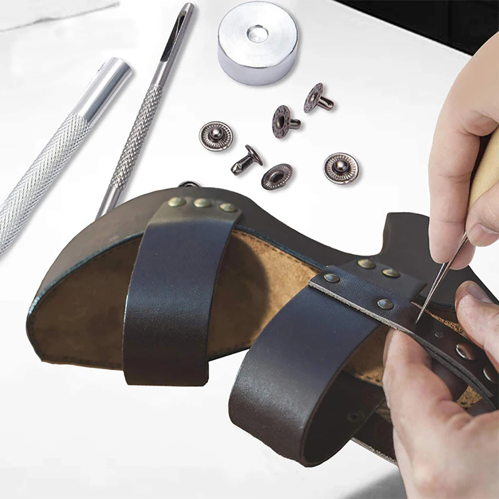 A professional leather crafting kit showing tools like a punch, various metal findings, and a leather tool.
