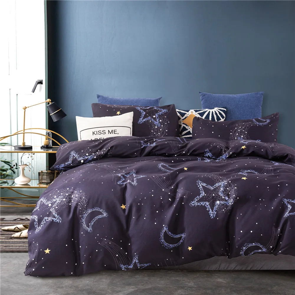 A dark purple starry sky duvet cover set with blue and white accent pillows on a bed.