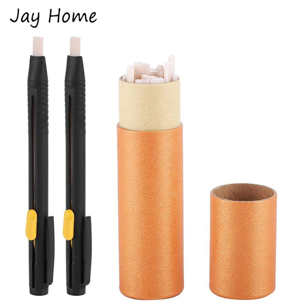A set of black fabric marking chalk pens with yellow caps and orange cardboard tubes for sewing and quilting