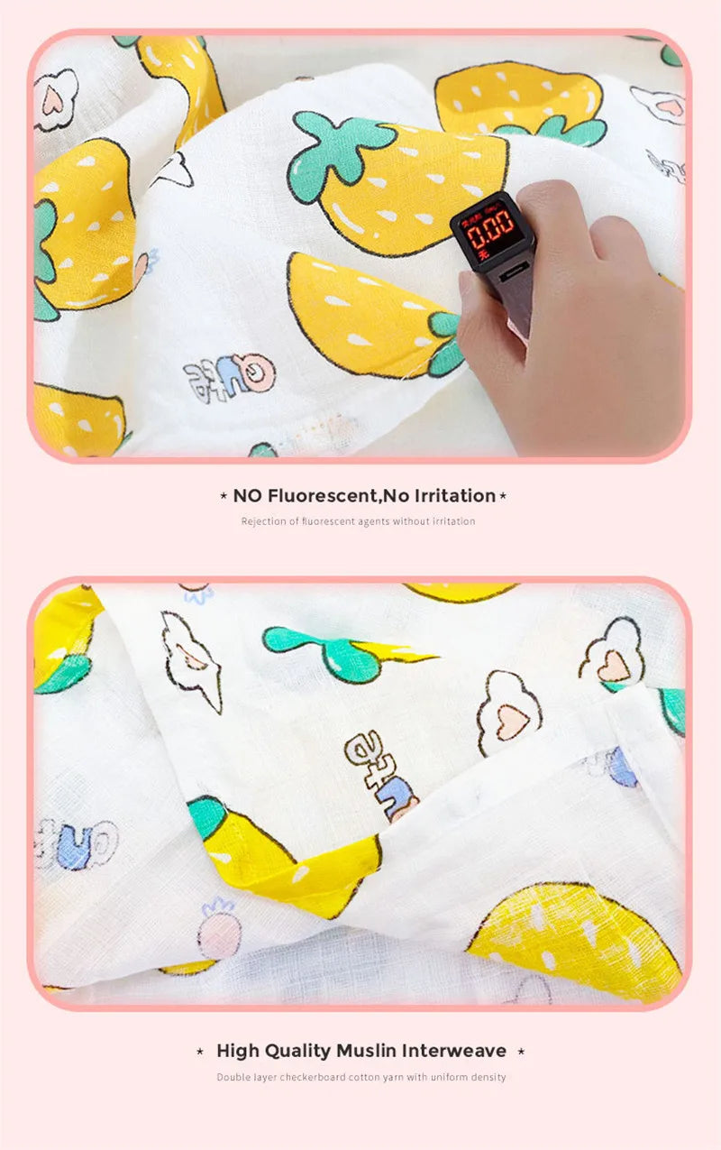 A white muslin swaddle blanket with yellow and green designs is shown next to a digital watch.
