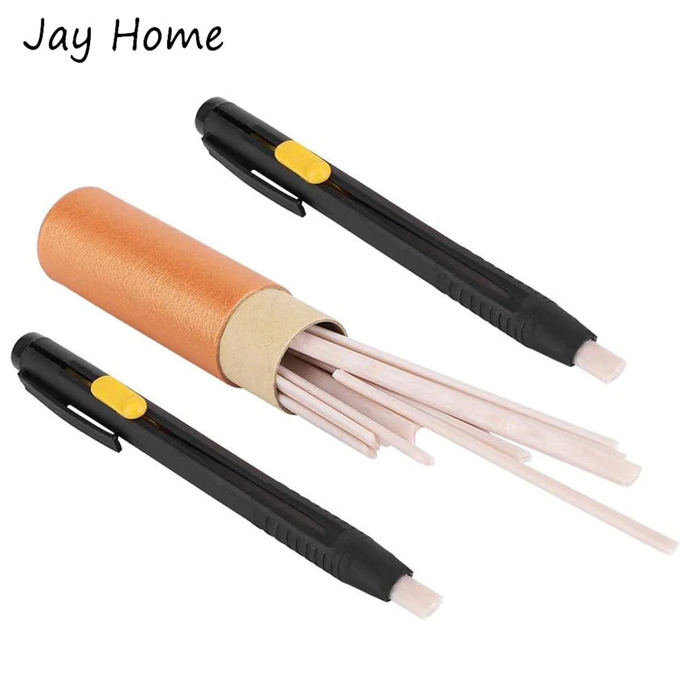 A set of fabric marking chalk pens with orange and beige colored tips and black handles.