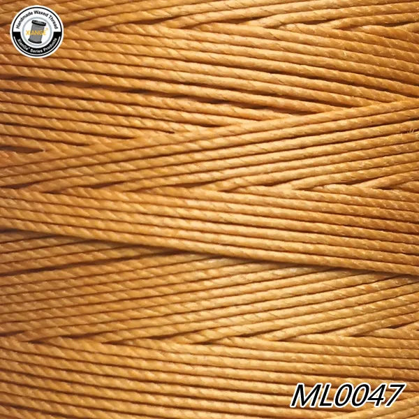 A close-up view of orange waxed thread embroidery cord stacked in a spool.