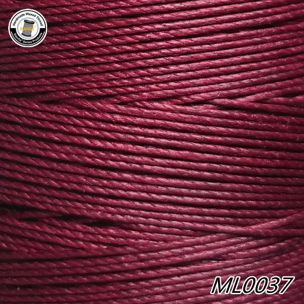 A close-up of deep magenta waxed thread embroidery cord with a black label and the product code ML0037.