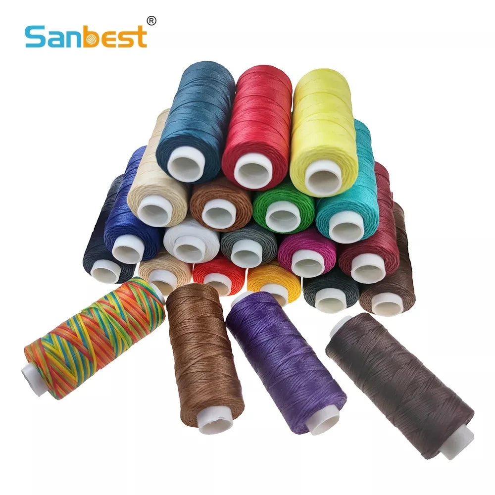 A collection of various colored leather craft threads and yarns rolled into spools.