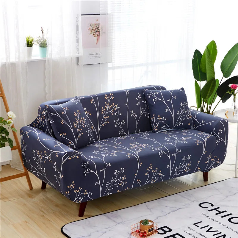 Navy stretch floral elastic sofa covers displayed on a wooden floor near a window.