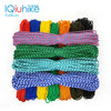 A collection of multi-colored paracord ropes in various colors and thicknesses laid out for display.
