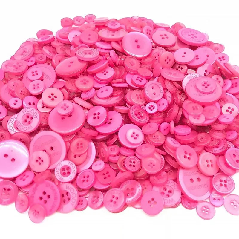 A pile of various pink and magenta wooden buttons for scrapbooking