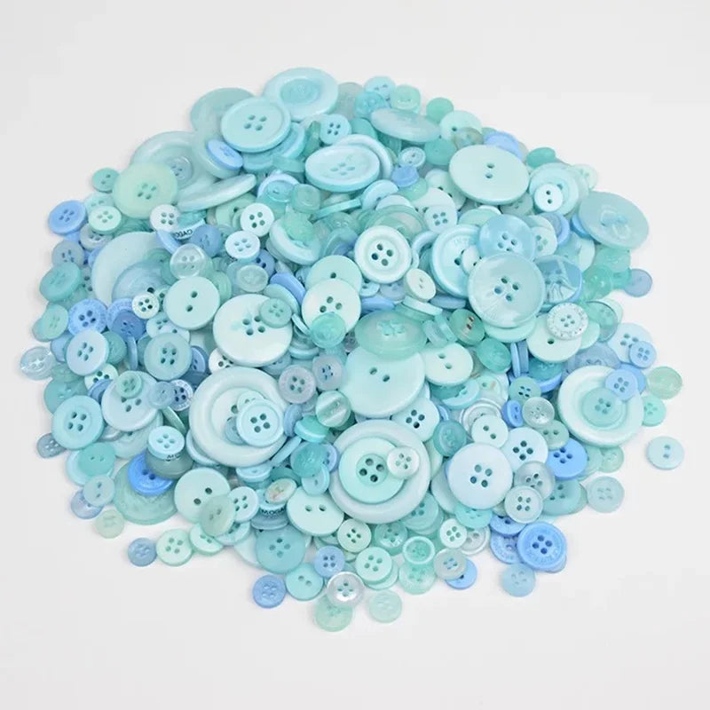 A pile of light blue and teal wooden buttons in various sizes for scrapbooking