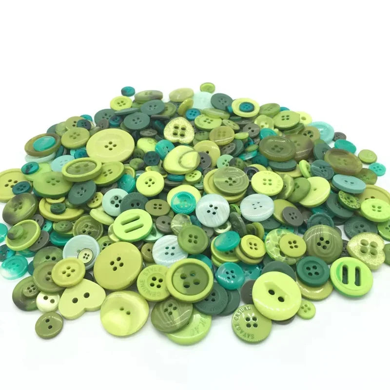A pile of assorted mix size wooden buttons in various shades of green and teal.