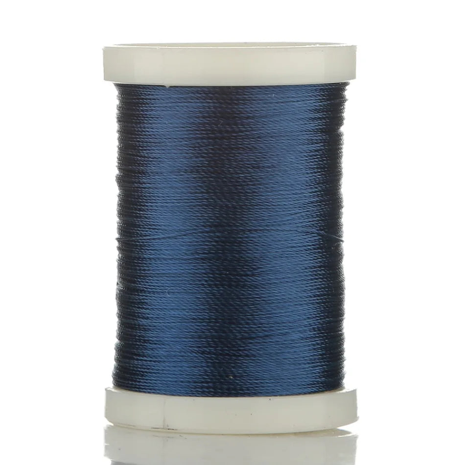 Spool of dark blue multi-braided polyester fishing line on a white background