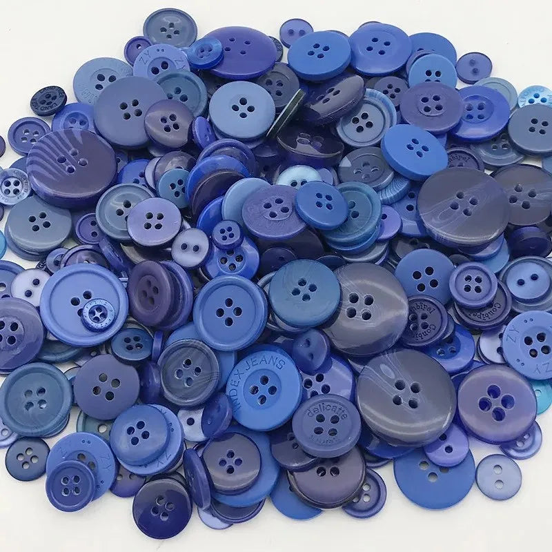 A pile of various sized wooden buttons in shades of blue and purple for scrapbooking