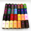 A collection of waxed threads in various colors and thicknesses arranged in rows.