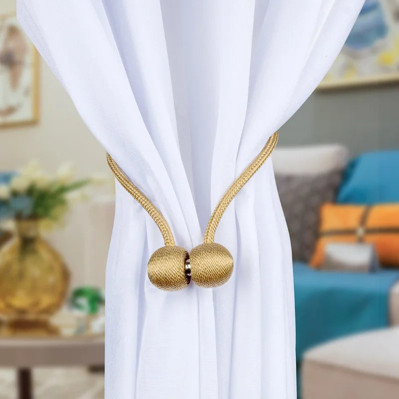 Gold magnetic pearl ball curtain tiebacks on white fabric