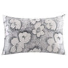 A square pillowcase with a gray and white floral print on a textured background.